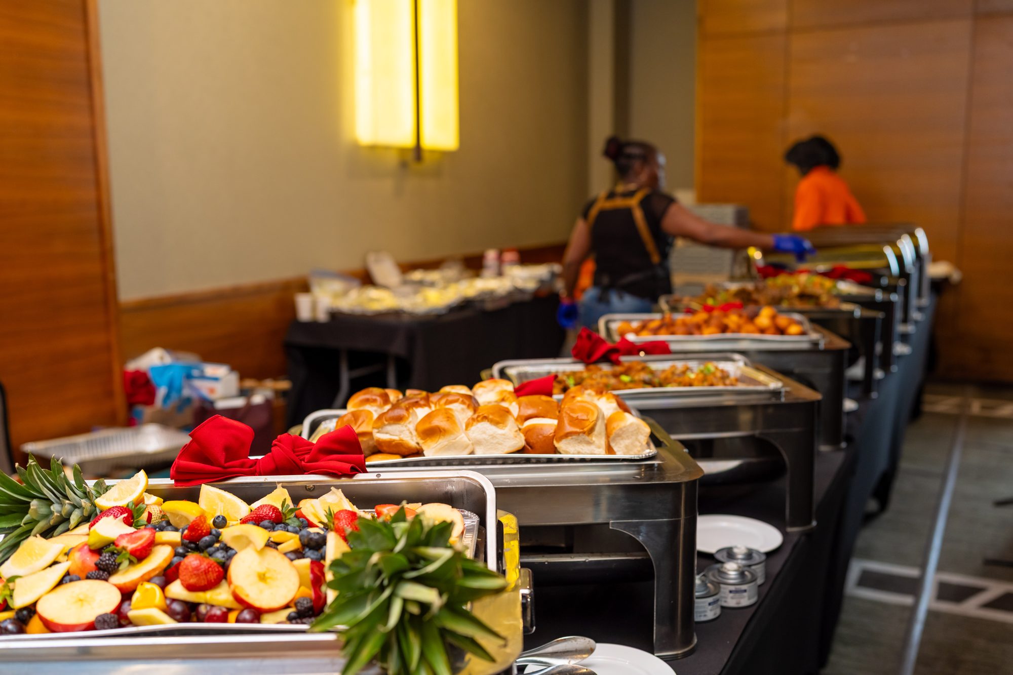 NativPott catering buffet at a Calgary event, with fresh fruit, bread rolls and hot chafing dishes served by the NativPott team